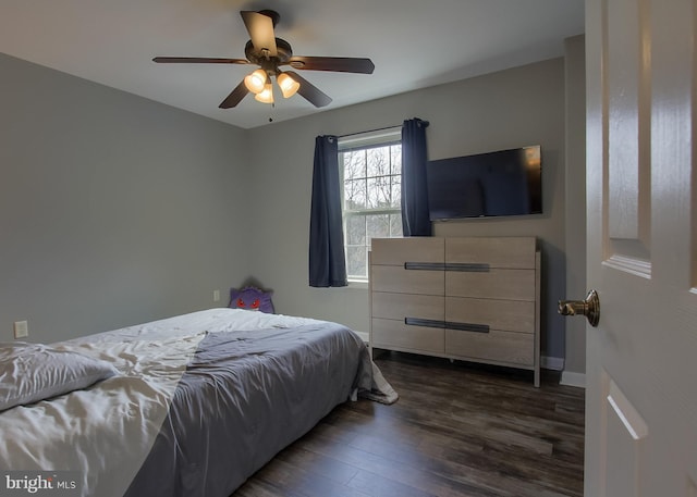 bedroom featuring baseboards, dark wood-type flooring, and ceiling fan