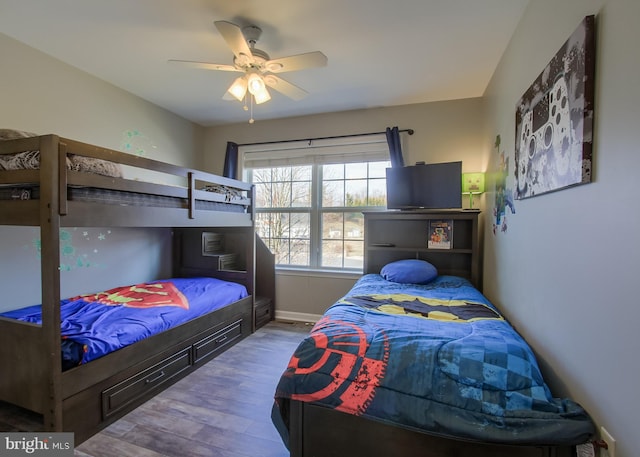 bedroom featuring baseboards, a ceiling fan, and wood finished floors