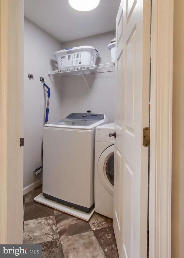 clothes washing area with independent washer and dryer and laundry area