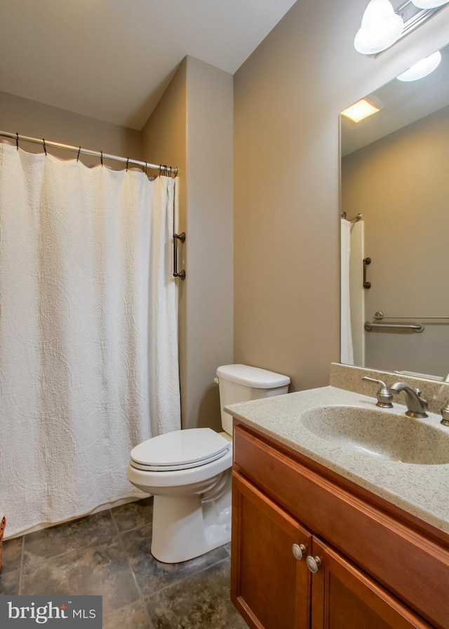 full bathroom with toilet and vanity