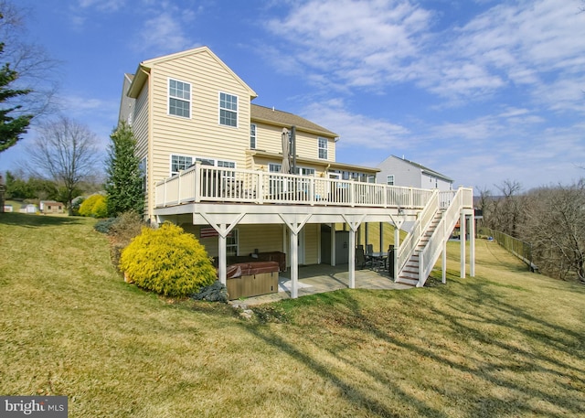 rear view of house with a patio, a lawn, a deck, and a hot tub