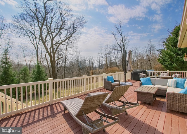 wooden deck featuring an outdoor living space and grilling area