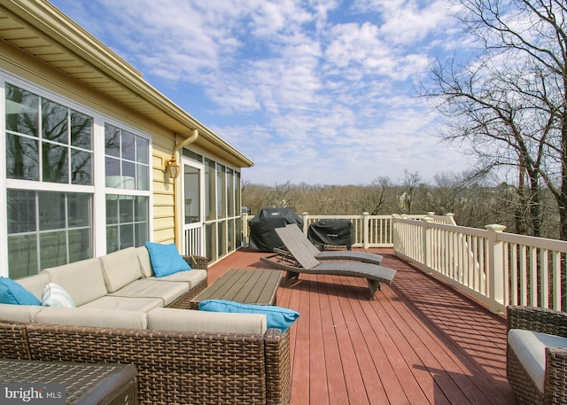 wooden deck with grilling area and outdoor lounge area