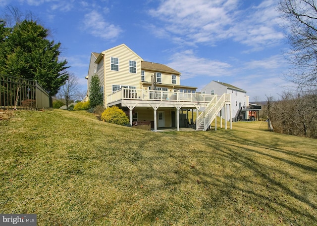 back of house with a deck, stairway, and a yard