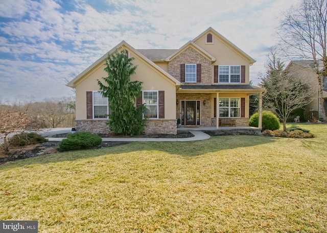 view of front of property with stucco siding, stone siding, and a front yard