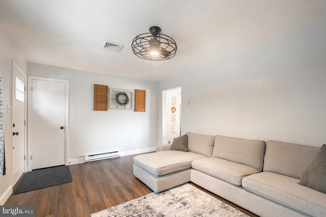 unfurnished living room featuring wood-type flooring, ceiling fan, and a baseboard heating unit