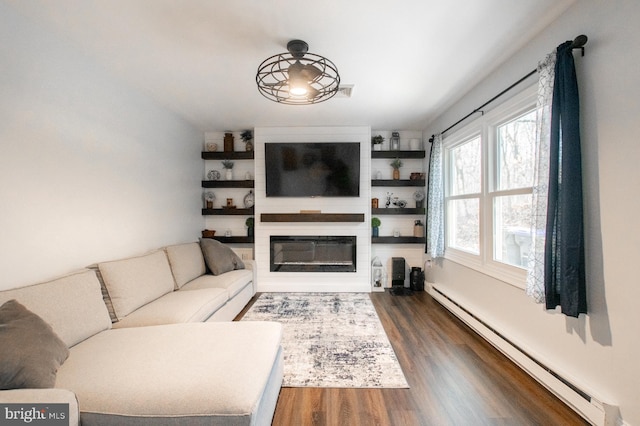 living room with dark hardwood / wood-style flooring and a baseboard heating unit