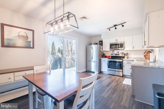 dining area with dark hardwood / wood-style flooring and sink