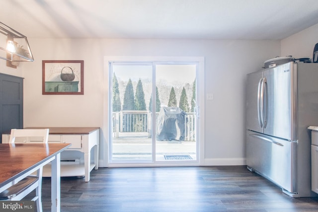 dining space with dark hardwood / wood-style flooring