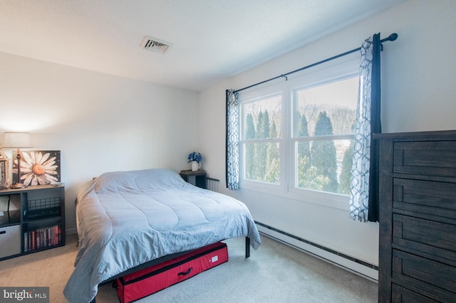 carpeted bedroom featuring a baseboard heating unit