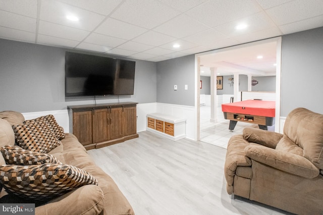 living room with light hardwood / wood-style floors and pool table