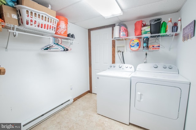 clothes washing area featuring independent washer and dryer and a baseboard heating unit