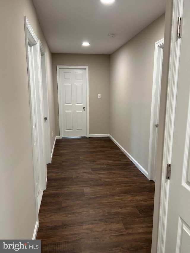 corridor featuring dark wood-type flooring