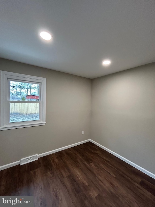 empty room with dark hardwood / wood-style floors