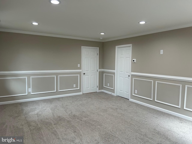 spare room with crown molding and carpet