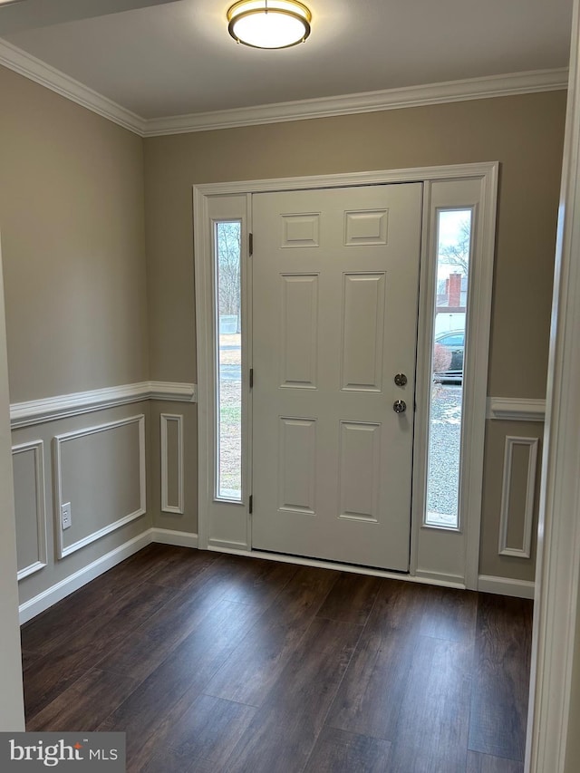 entrance foyer with ornamental molding and dark hardwood / wood-style flooring