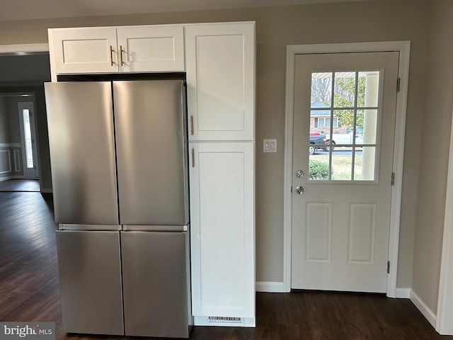 kitchen with white cabinetry, stainless steel fridge, and dark hardwood / wood-style floors