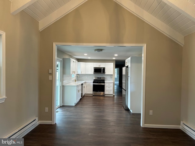 kitchen with white cabinets, a baseboard heating unit, stainless steel appliances, vaulted ceiling with beams, and sink