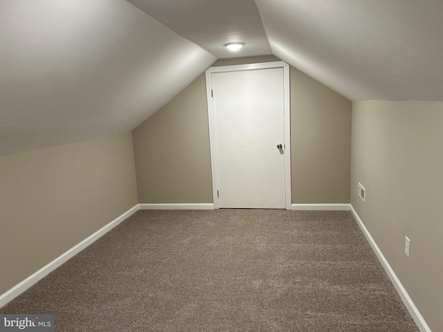 bonus room with lofted ceiling and carpet