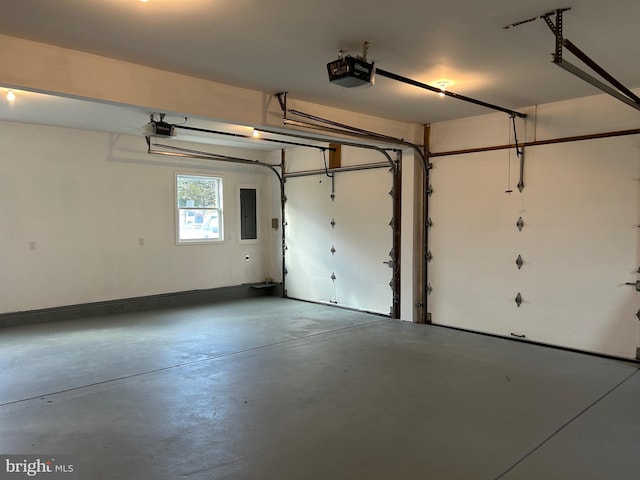 garage featuring electric panel and a garage door opener