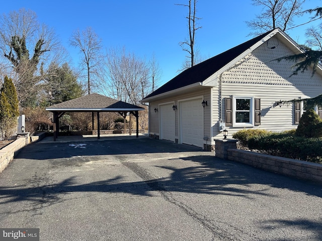 view of side of property featuring a gazebo and a carport