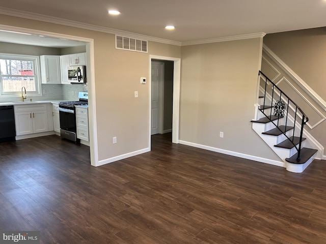 unfurnished living room featuring sink, dark hardwood / wood-style flooring, and ornamental molding