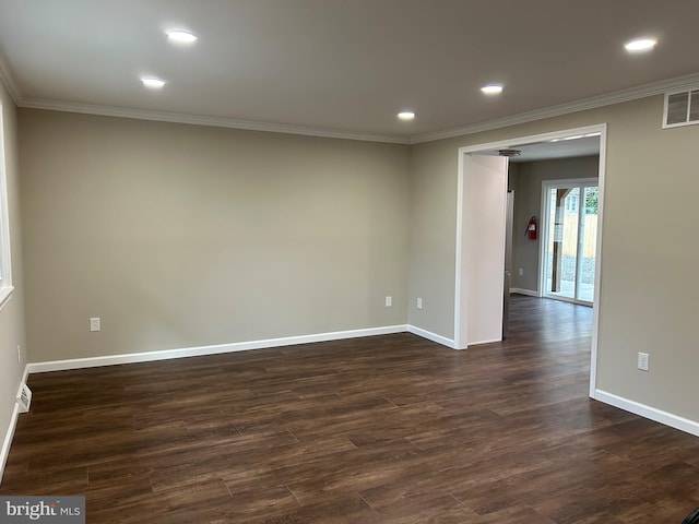 empty room featuring ornamental molding and dark wood-type flooring