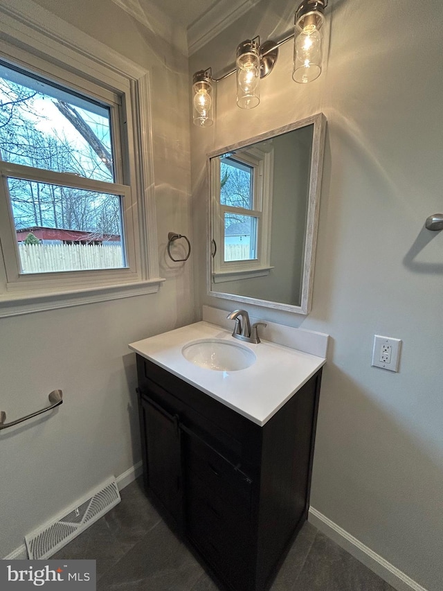 bathroom with ornamental molding, tile patterned flooring, and vanity