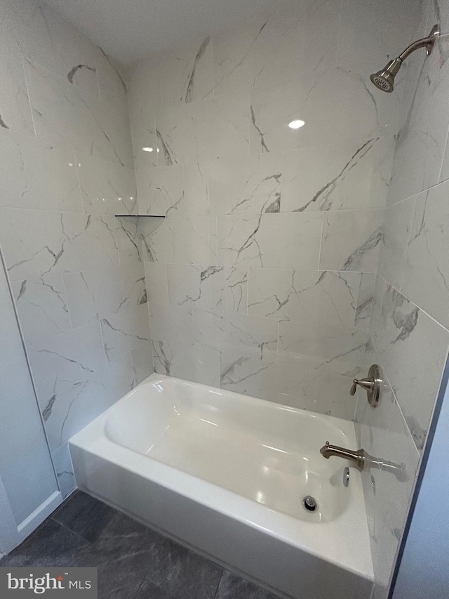 bathroom featuring shower / washtub combination and tile patterned flooring