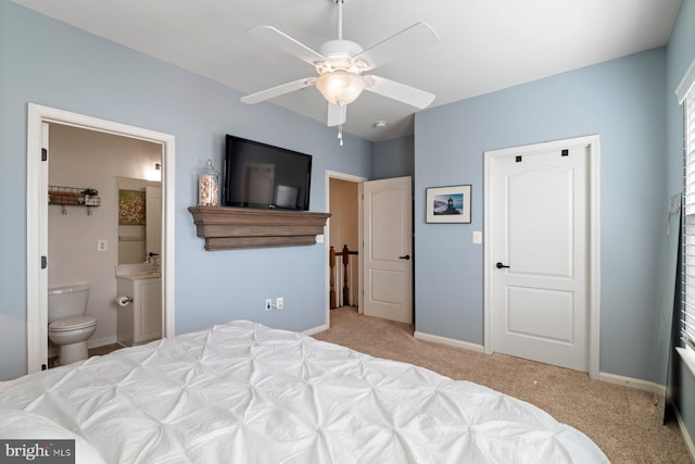 carpeted bedroom with connected bathroom and ceiling fan