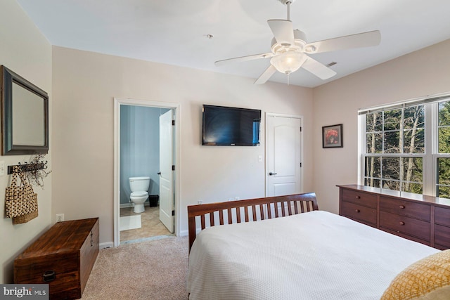 carpeted bedroom featuring connected bathroom and ceiling fan