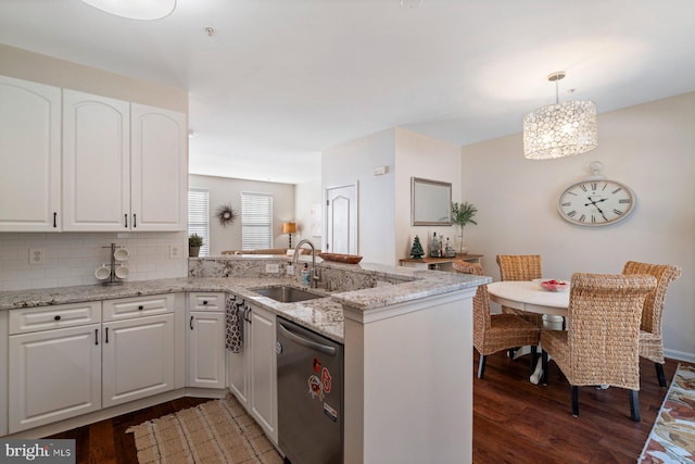 kitchen with white cabinetry, dark hardwood / wood-style flooring, decorative light fixtures, stainless steel dishwasher, and kitchen peninsula