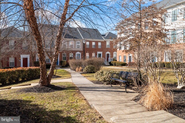 view of property's community with a lawn