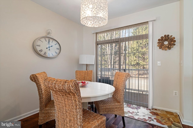 dining room featuring an inviting chandelier, dark hardwood / wood-style floors, and a wealth of natural light