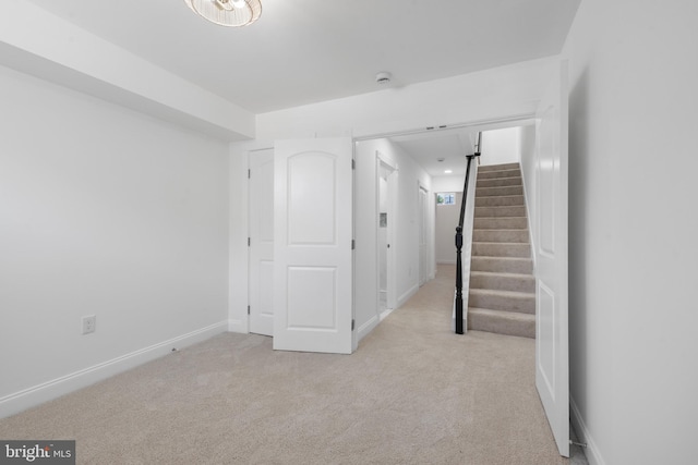 basement featuring light colored carpet