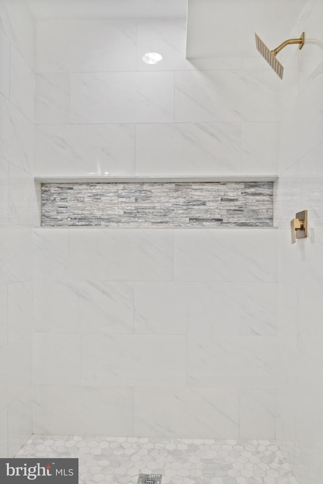 bathroom with tiled shower