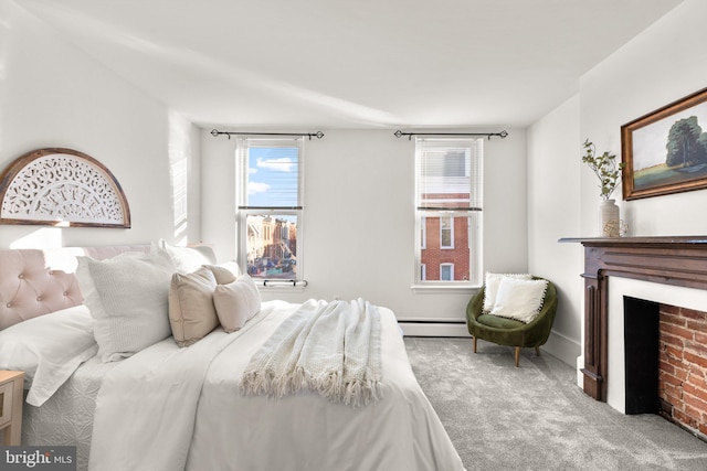 bedroom featuring light carpet and a baseboard heating unit