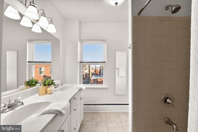 bathroom featuring tile patterned floors, a wealth of natural light, vanity, and a baseboard heating unit