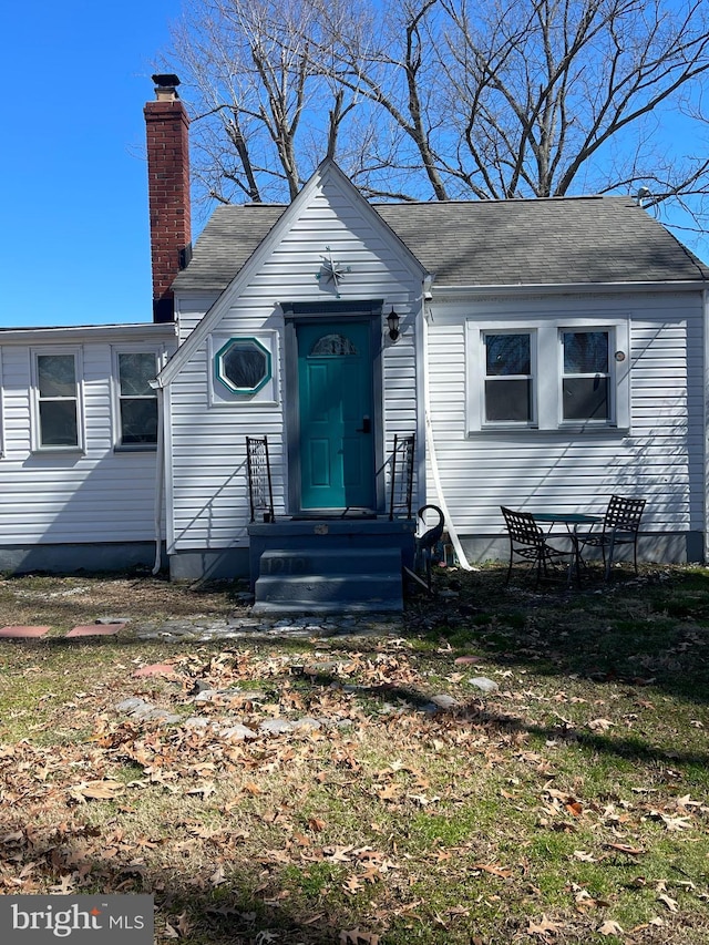 bungalow-style house featuring a chimney