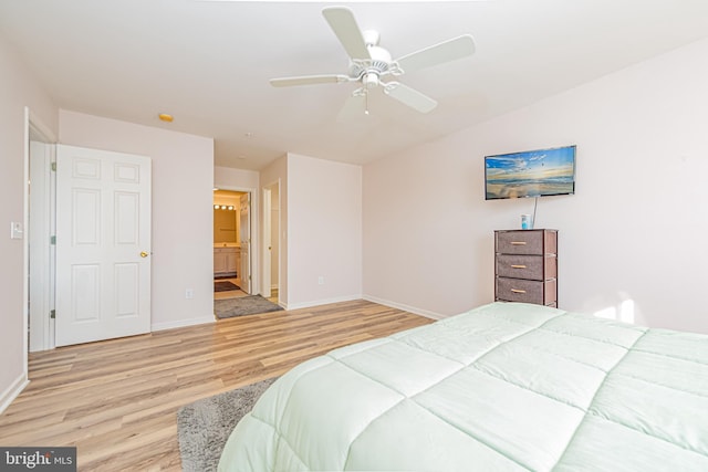 bedroom with ceiling fan, ensuite bathroom, and light hardwood / wood-style flooring