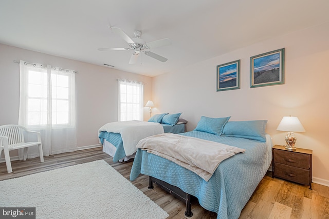 bedroom with ceiling fan and hardwood / wood-style flooring