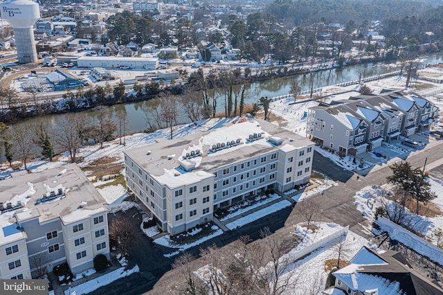 snowy aerial view featuring a water view