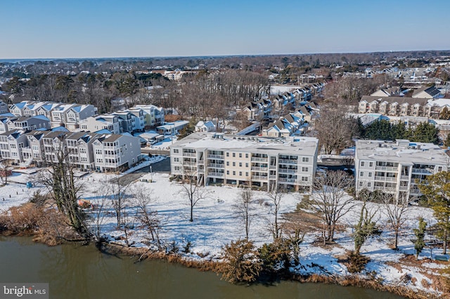 snowy aerial view featuring a water view