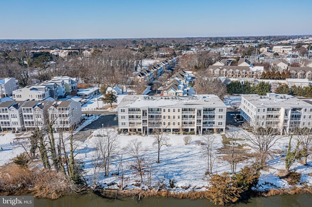 snowy aerial view featuring a water view