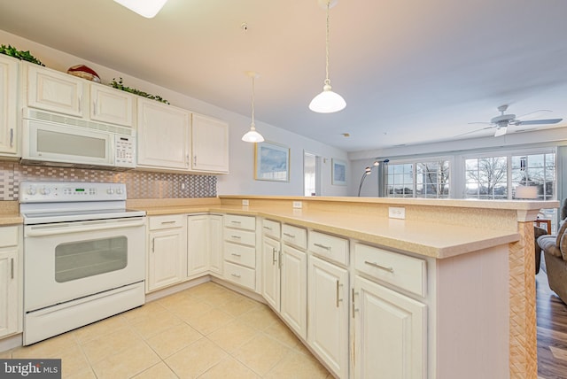 kitchen featuring kitchen peninsula, ceiling fan, tasteful backsplash, decorative light fixtures, and white appliances