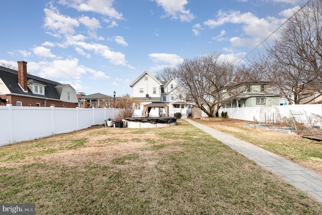 view of yard featuring a gazebo and a fenced backyard