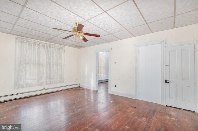 unfurnished room featuring wood-type flooring, a paneled ceiling, and a baseboard radiator