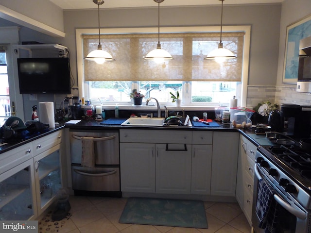 kitchen with sink, white cabinets, and decorative light fixtures