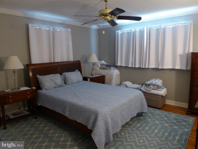 bedroom with hardwood / wood-style flooring, ceiling fan, and crown molding