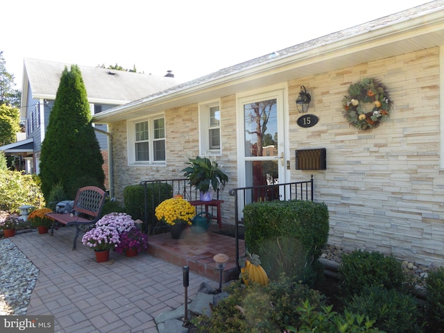 doorway to property featuring a patio